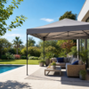 Modern patio with a quick shade canopy, lounge seating, and a pool in a lush garden.